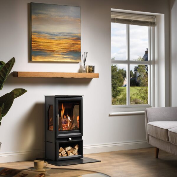 Charlton and Jenrick Paragon Edge 3S balanced flue gas stove, shown on a log store