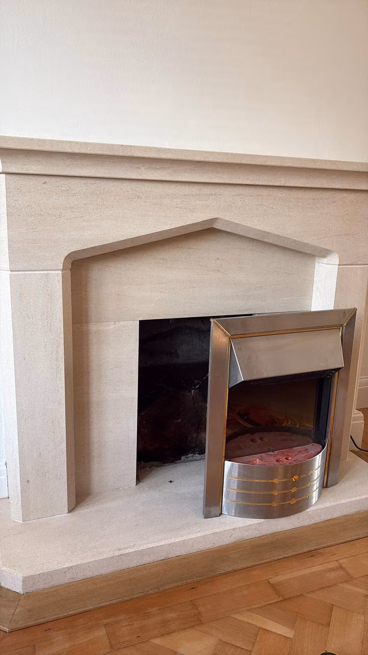 Metal fire unit pulled forward from the fireplace opening