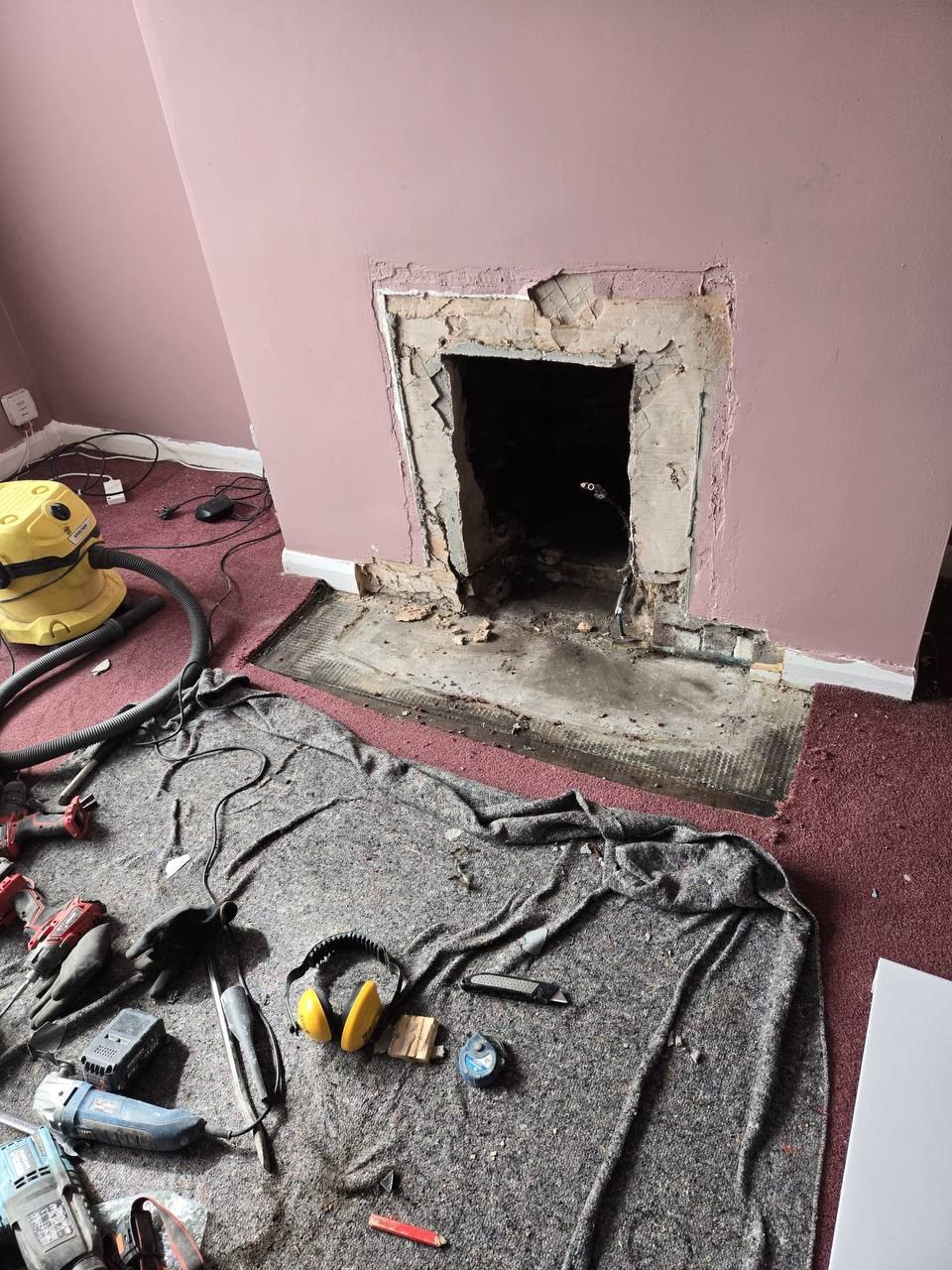 Fireplace opening stripped back during installation before the new Bilbao fireplace was fitted